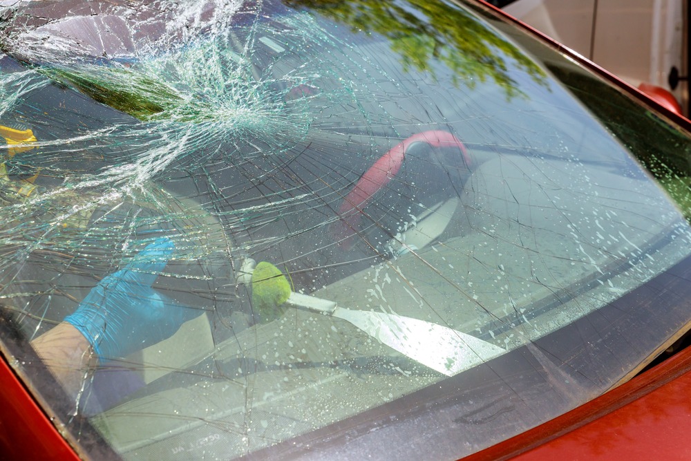 A car's windshield cracked so bad that it needs to be replaced.