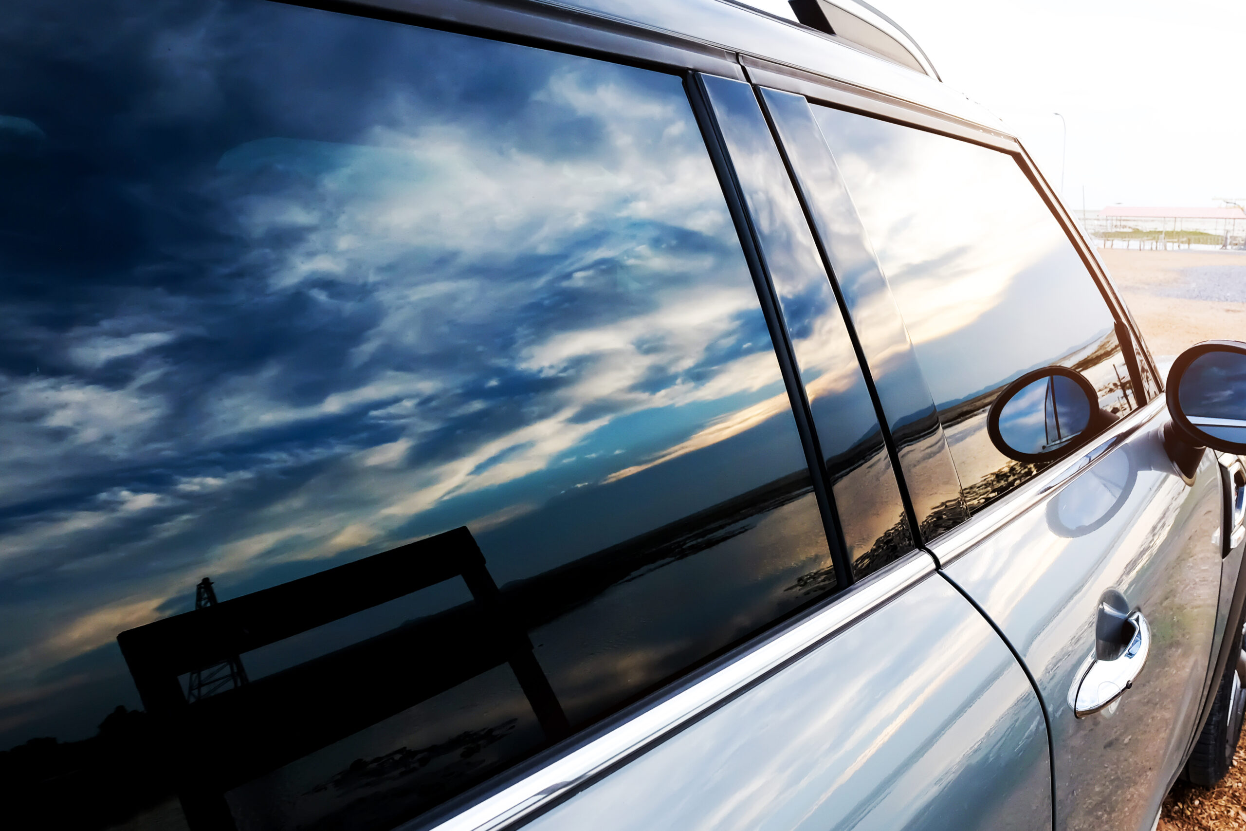 Auto Back Glass Replacement: What Happens to My Defroster and Antenna? 1 Vehicle glass surface showing rear and side auto glass detail