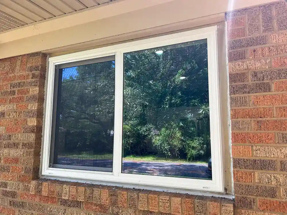 Newly installed modern sliding window with clear panes.