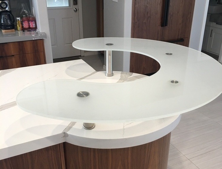 Frosted glass countertop with a curved design.